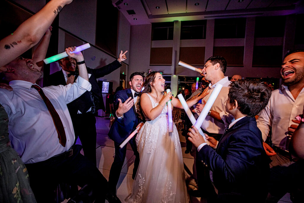Bride dancing with guests at high-energy wedding reception in Miami, captured #IRL by Zeta Event Productions and Victoria Machin Photography