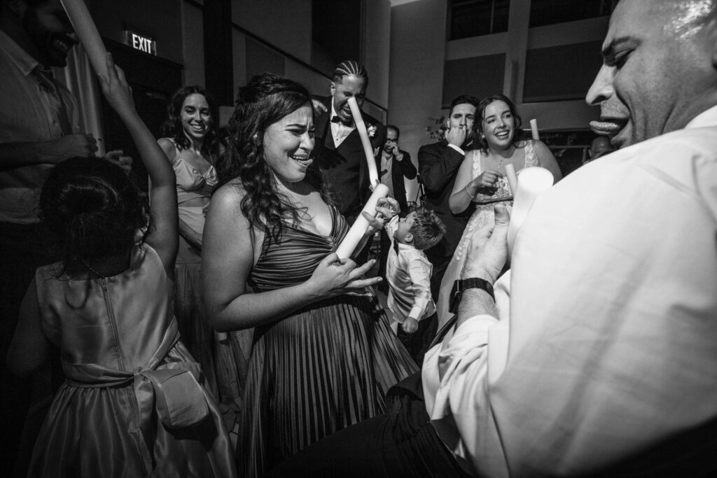 Guests laughing, dancing, and celebrating a real-life wedding moment during a high-energy reception in Miami, captured by Zeta Event Productions and Victoria Machin Photography #IRL

